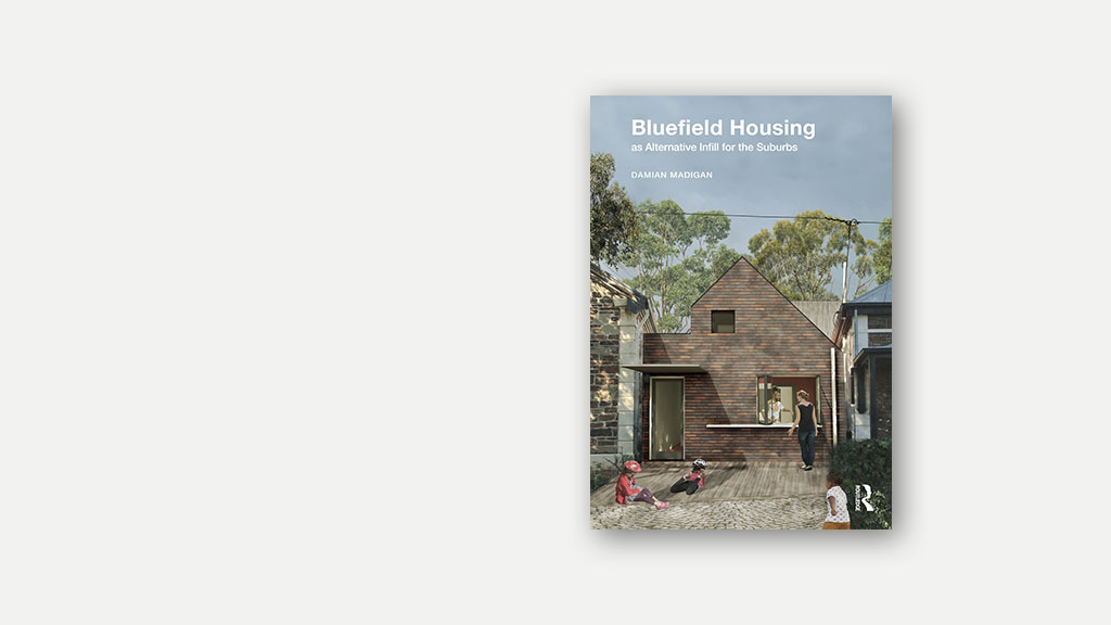 A photograph of the paperback version of the book 'Bluefield Housing as Alternative Infill for the Suburbs' by Damian Madigan.