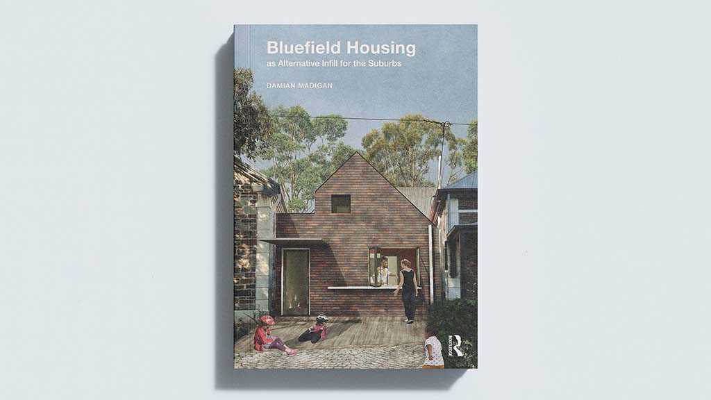 A photograph of the front cover of the paperback version of the book 'Bluefield Housing as Alternative Infill for the Suburbs' by Damian Madigan.